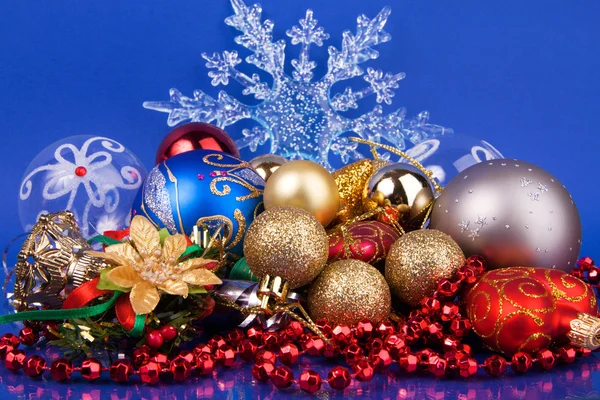 Christmas toys on blue background with snowflake — Stock Photo, Image