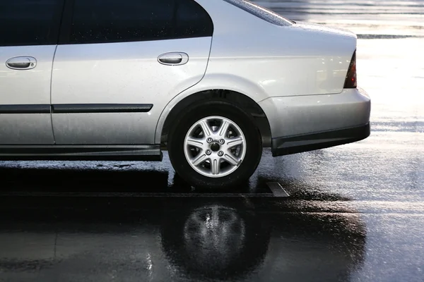 stock image Silver car on parking in the rain