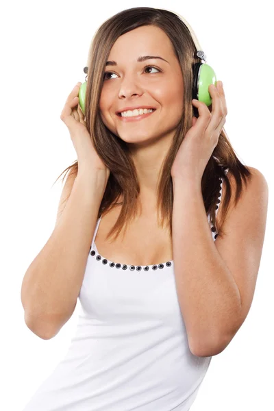 Mooi meisje een muziek in koptelefoon luisteren — Stockfoto