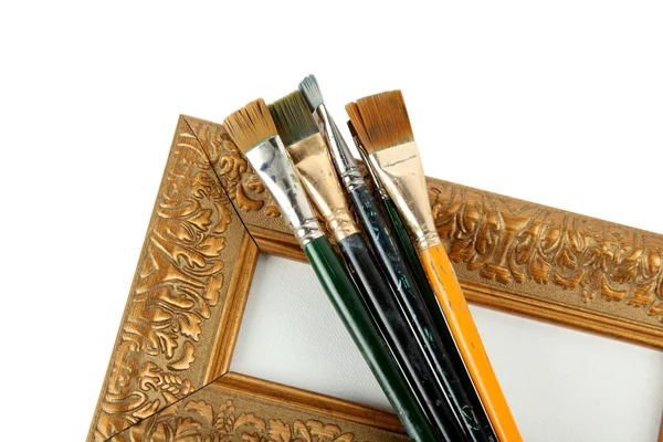 Antique frame and paintbrushes — Stock Photo, Image