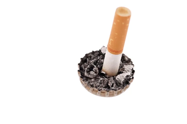 Cigarette butt in a bottle cap on white background — Stock Photo, Image