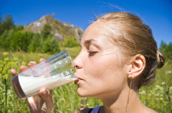 Girl drinks milk. — Stock Photo, Image