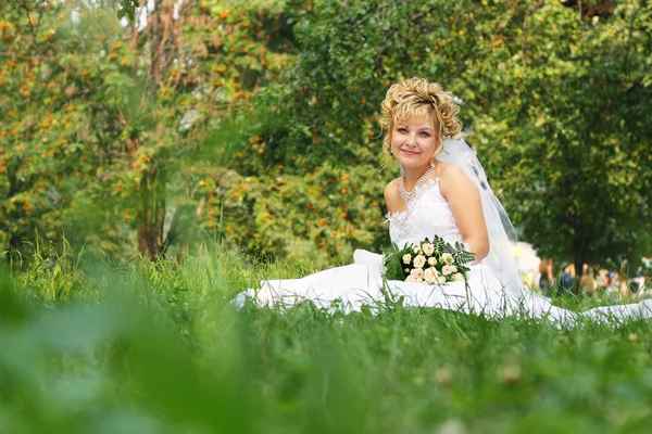 stock image Happy bride at a park in grass