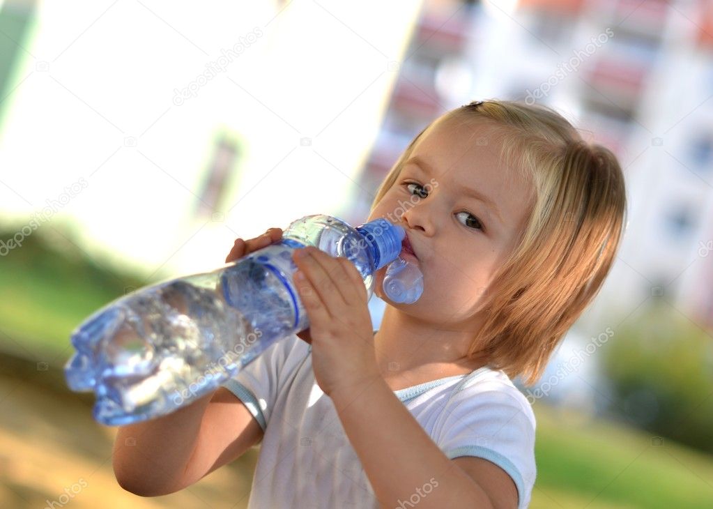 Young Girl Drinks Pure Water From A Bottle On The 