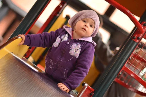 Petite fille jouant sur l'aire de jeux pour enfants — Photo