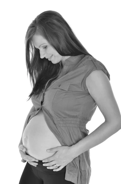 Mulher grávida acariciando sua barriga sobre fundo branco — Fotografia de Stock