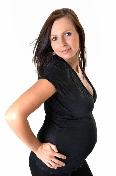 Mulher grávida acariciando sua barriga sobre fundo branco — Fotografia de Stock