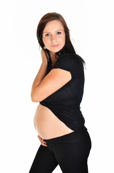 Hamile bir kadın beyaz arka planda karnını okşuyor. — Stok fotoğraf