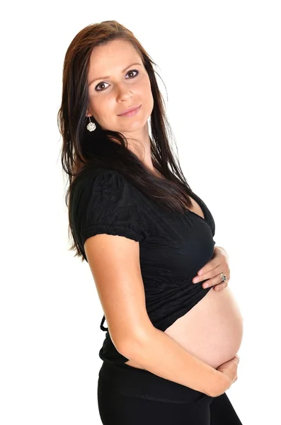 Беременная женщина ласкает живот на белом фоне — стоковое фото