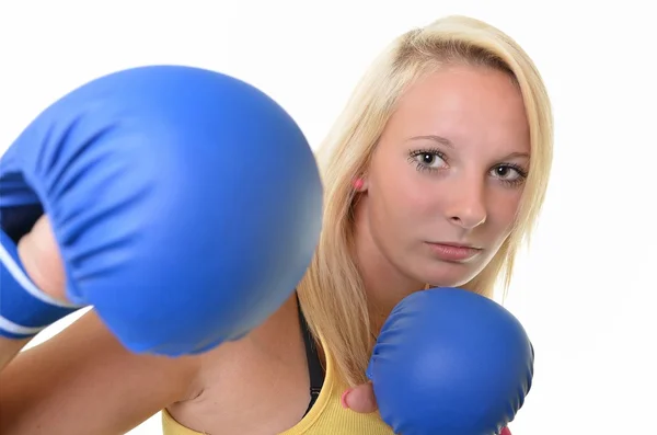 A portrait of a young, blonde woman, wearing blue boxing gloves — Stock Photo, Image
