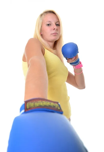 A portrait of a young, blonde woman, wearing blue boxing gloves — Stock Photo, Image