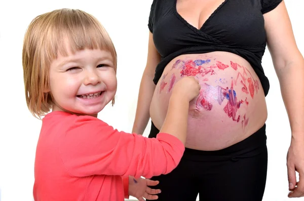 Little Girl painting on belly — Stock Photo, Image