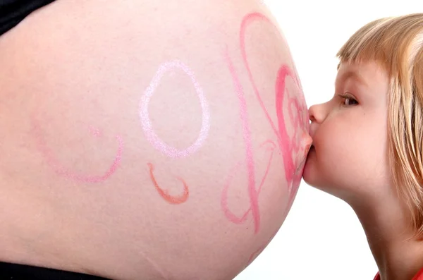 Little Girl Kissing New Sibling to Be — Stock Photo, Image