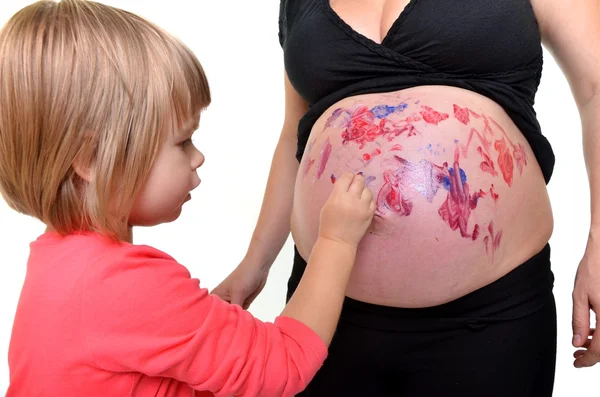Baby painting on pregnant belly — Stock Photo, Image