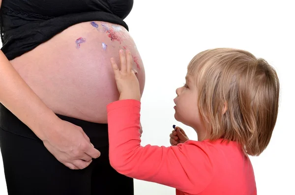 Baby painting pregnant woman — Stock Photo, Image