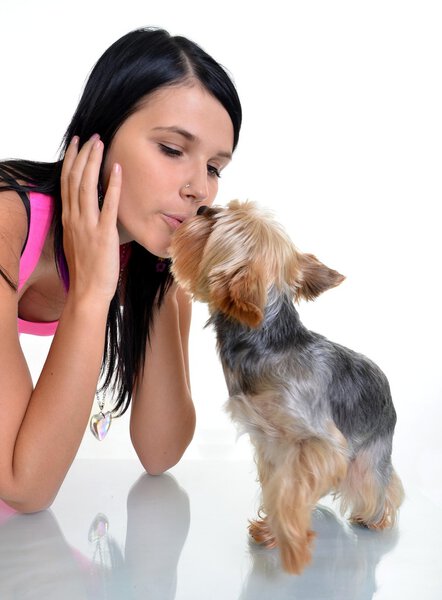 Young woman and sweet puppy playing around