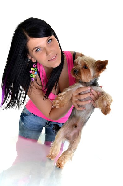 Young woman and sweet puppy playing around