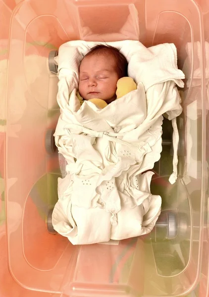 Newborn baby in open plastic box — Stock Photo, Image