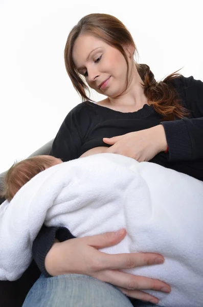 Mother feeding her newborn baby with breast - indoors — Stock Photo, Image