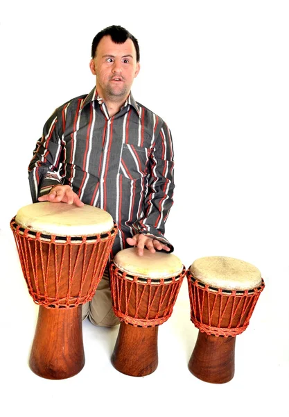 Happy man with down syndrome playing on drum. — Stock Photo, Image