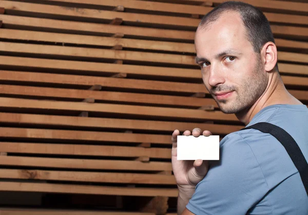 stock image Craftsman holding a business card