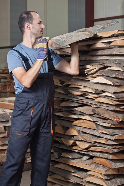 Man arraging planks, vertical — Stock Photo, Image