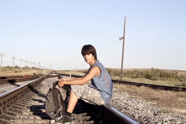 Teen boy on rail road — Stock Photo, Image