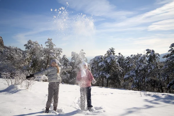 Two girls playing on snow — Stock Photo, Image