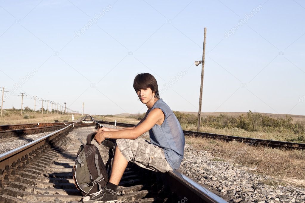 Teen boy on rail road