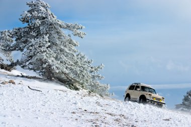 Off-road car on winter landscape clipart