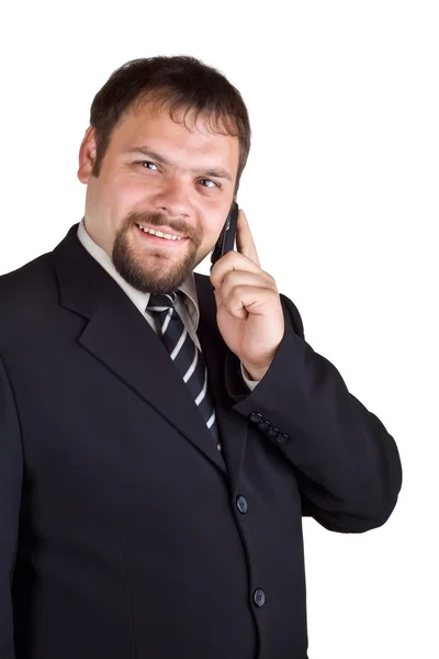 Un hombre de negocios sonriente hablando por un teléfono celular — Foto de Stock