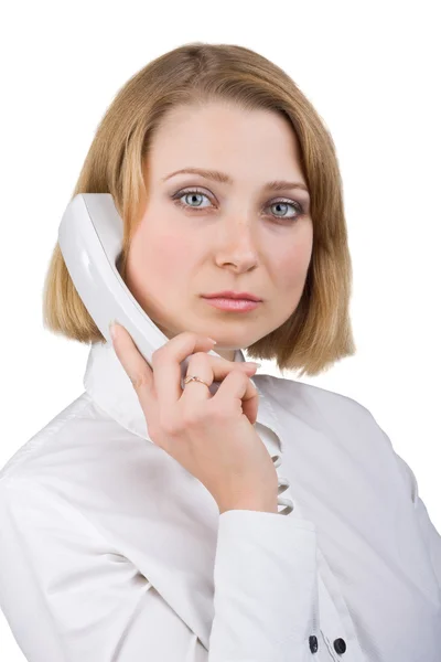 Business woman in a white blouse with a telephone receiver in hand — Stok fotoğraf