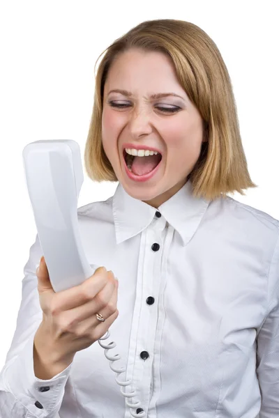 Business woman shouting into the telephone receiver — Stock Photo, Image