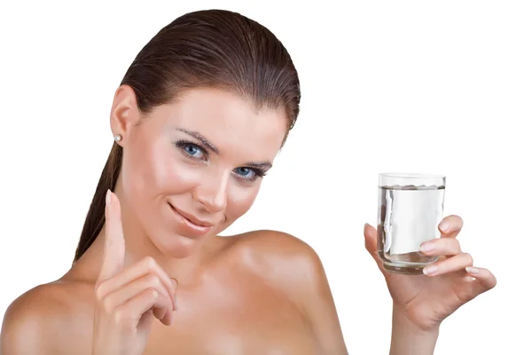 Frau hält ein Glas Wasser und zeigt den Zeigefinger — Stockfoto