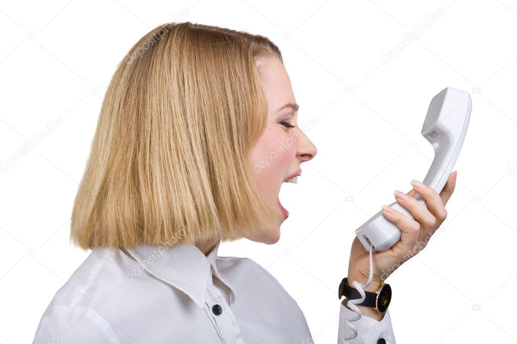 Business woman shouting into the telephone receiver