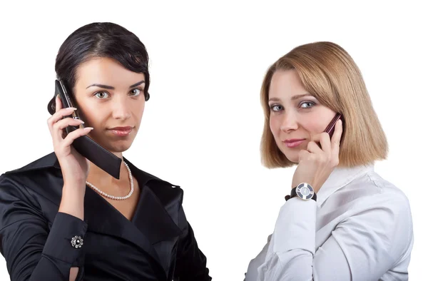 Two business women talking on mobile phone — Stock Photo, Image
