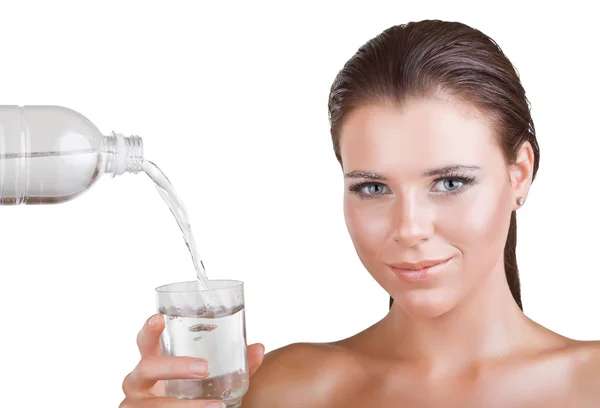 Beautiful woman holding a glass in which the water pours — Stock Photo, Image