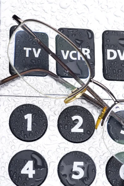 Controle remoto e óculos — Fotografia de Stock