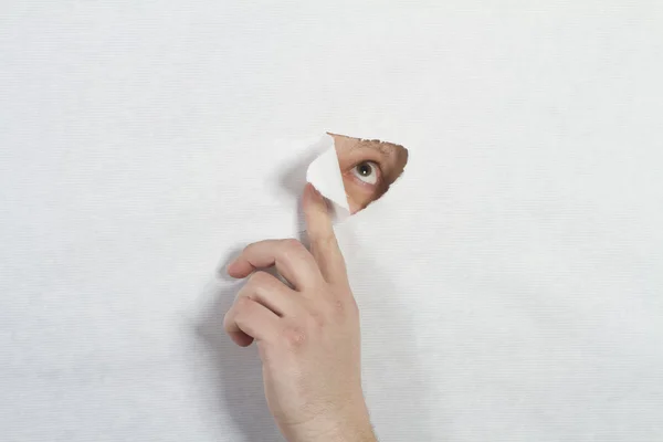 stock image Peeking through a hole