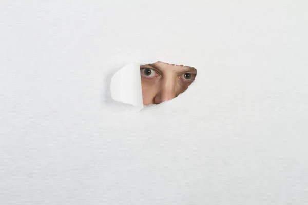 stock image Peeking through a hole