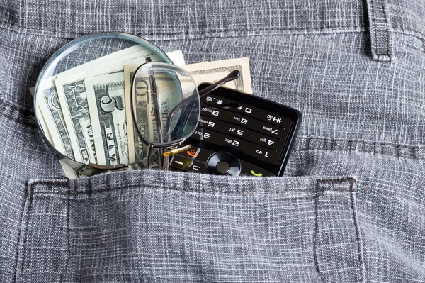 Dollar with phone in pocket — Stock Photo, Image