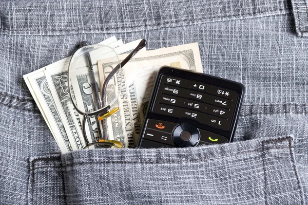 Dollar with phone in pocket — Stock Photo, Image