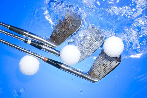 Golf club in blue water Royalty Free Stock Photos