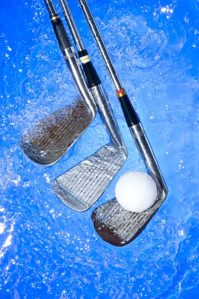 Golf club in blue water Royalty Free Stock Images