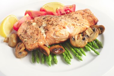 Pan-seared salmon steak and veg clipart