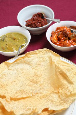 Poppadoms with indian pickles clipart