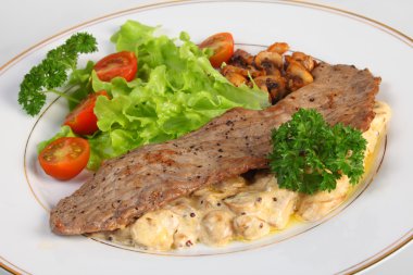 Veal escalope and mushrooms in cream sauce clipart