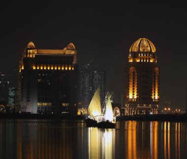 Dhows in Qatar at night clipart