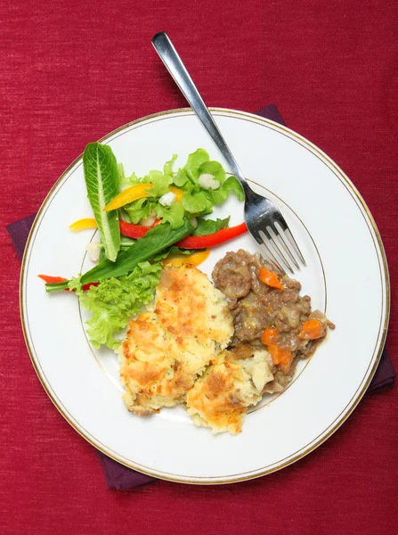 Shepherd's pie meal with fork on a tablecloth — Stock Photo, Image