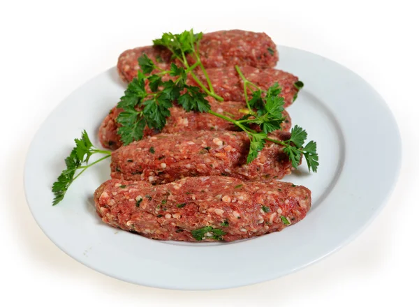 Raw lamb kofta on a plate — Stock Photo, Image
